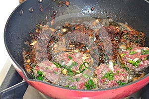 Frying pan with fried beef cutlets