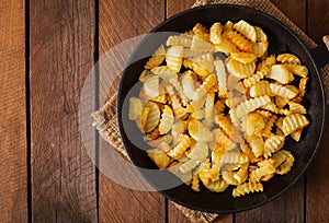 Frying pan with a fried potato in a rural way