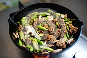 Frying pan full of morels and asparagus