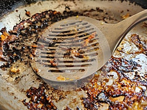 Frying pan with the remains of burnt scrambled eggs
