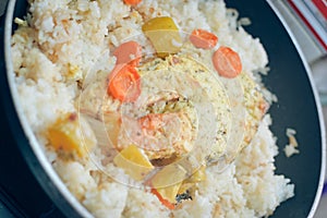 Frying pan with seafood salmon with rice and herbs. Top View.