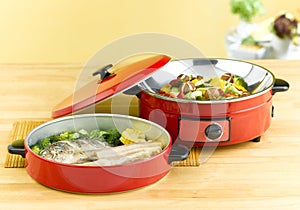 Frying pan, steaming pot in the kitchen interior