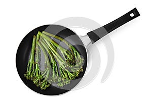 Frying pan with tasty cooked broccolini isolated on white, top view