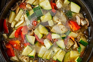 Frying pan with vegetables cut for stewing in sauce and spices.