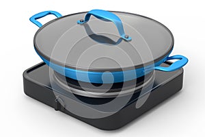 Frying pan or wok with glass lid on portable camping electric stove