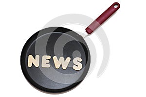 Frying pan with the word news from wooden letters. News preparation concept. Isolate on white background, photography