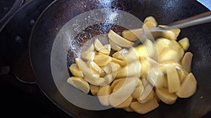 Frying of potatoes in a kazan on a gas grill