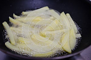 Frying potatoes in a pan