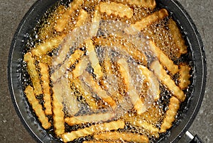 Frying potatoes in pan with oil