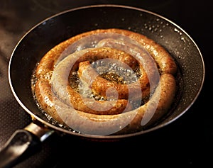 Frying rounded sausages in fry