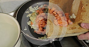 Frying salmon pieces in a cream