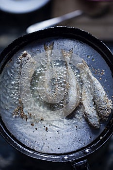 Frying small sardines fish, Chefchouen, Morocco photo