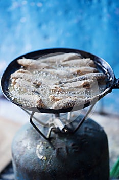 Frying small sardines fish, Chefchouen, Morocco photo