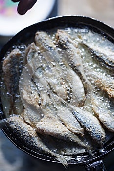 Frying small sardines fish, Chefchouen, Morocco photo