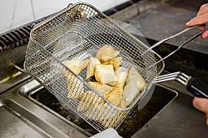 Frying torta frita in a steel basket photo