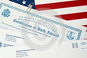 Fs-545 Certification of birth abroad lies on United States flag with envelope from Department of Homeland Security