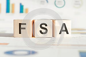 FSA on a wooden cubes on a white financial background