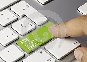 FTE Full Time Equivalent - Inscription on Green Keyboard Key photo