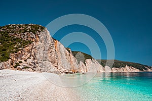 Fteri beach in Kefalonia Island, Greece. One of the most beautiful untouched pebble beach with pure azure emerald sea photo
