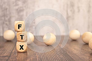 FTX . text on magnifier glass on white background. notepad on the desktop