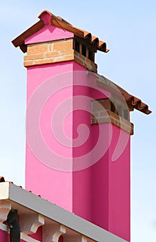 Fuchsia chimneys of houses of Burano island in Italy