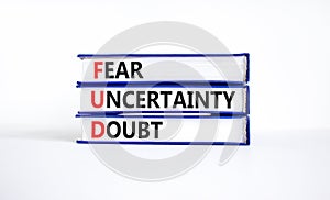 FUD fear uncertainty doubt symbol. Concept words FUD fear uncertainty doubt on books on a beautiful white table white background.