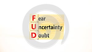 FUD fear uncertainty doubt symbol. Concept words FUD fear uncertainty doubt on wooden blocks on a beautiful white table white