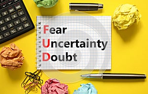 FUD fear uncertainty doubt symbol. Concept words FUD fear uncertainty doubt on white note on a beautiful yellow background.