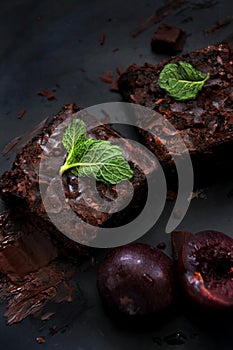 Fudge Brownies with Fruits on Dark Background