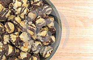 Fudge drizzled popcorn in an old bowl