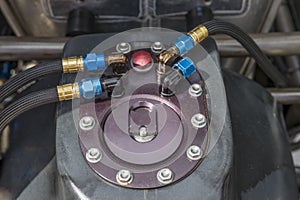 The fuel cap and connecting hoses on a speedway racing car