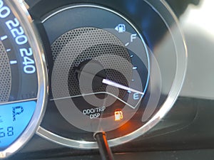 Fuel gauge showing empty tank with yellow glowing and lit meter