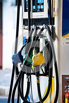 Fuel nozzles for diesel, petrol and speed showing a petrol pump fuel station in India the pricing of which is controlled