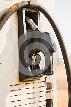 Fuel oil gasoline dispenser at petrol filling station.Holding fuel nozzle to refuel gasoline for car.