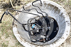 A fuel pump has all connector elements separated from the tractor engine for repair