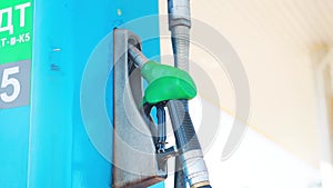 Fuel refueling pistol in a fuel pump at a gas station, close-up. Concept of rising fuel prices, price per liter of