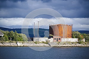 Fuel storage tank and derelict building at harbour in Greenock