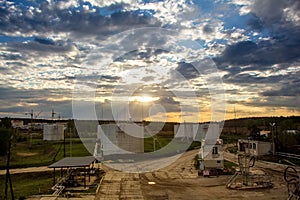 Fuel storage tanks for refueling airplanes on sunset background