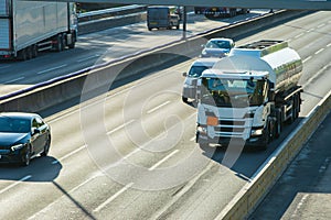 fuel tanker in traffic moving on uk motorway in England at sunset