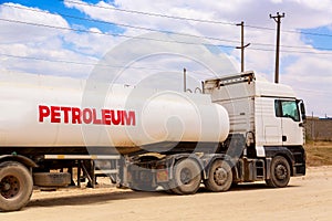 Fuel tanker truck gasoline transporter on the road. Fuel transportation concept