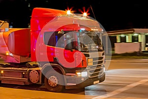 Fuel truck at night near a gas station