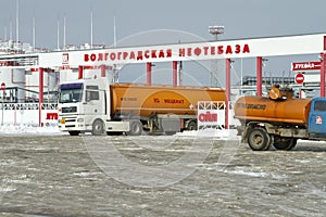 Fuel truck with an orange tank on the outskirts of