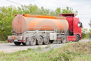 Fuel truck rides on a road in the countryside