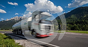 Fuel truck rushes down the highway in the background the Alps. Truck Car in motion blur