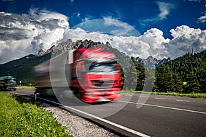 Fuel truck rushes down the highway in the background the Alps. Truck Car in motion blur