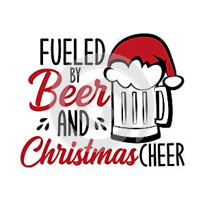 Fueled by beer and Christmas cheer - funny text , with Santa`s cap on beer mug. photo