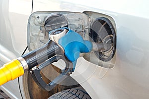 Fueling car gasoline, gun petrol fuel tank, closeup