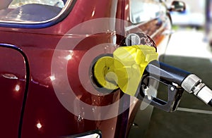 Fueling car with petrol at pump station photo