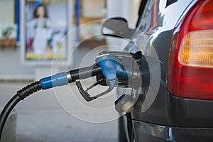 Fuelling nozzle inserted into the gas tank of the car