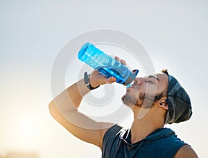 It fuels a better workout. a sporty young man drinking water while exercising outdoors.